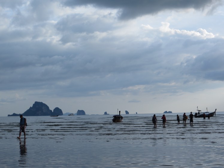 First lesson...clouds do not mean that it's cold.  It was a lovely temperature and we didn't wait any time before we headed out exploring.  Walking in the water at Nopparat Thara Beach people were collecting the live creatures that lived in shells that covered the ocean floor.  Crunch.  Crunch.  It was impossible not to step on the poor little guys :(