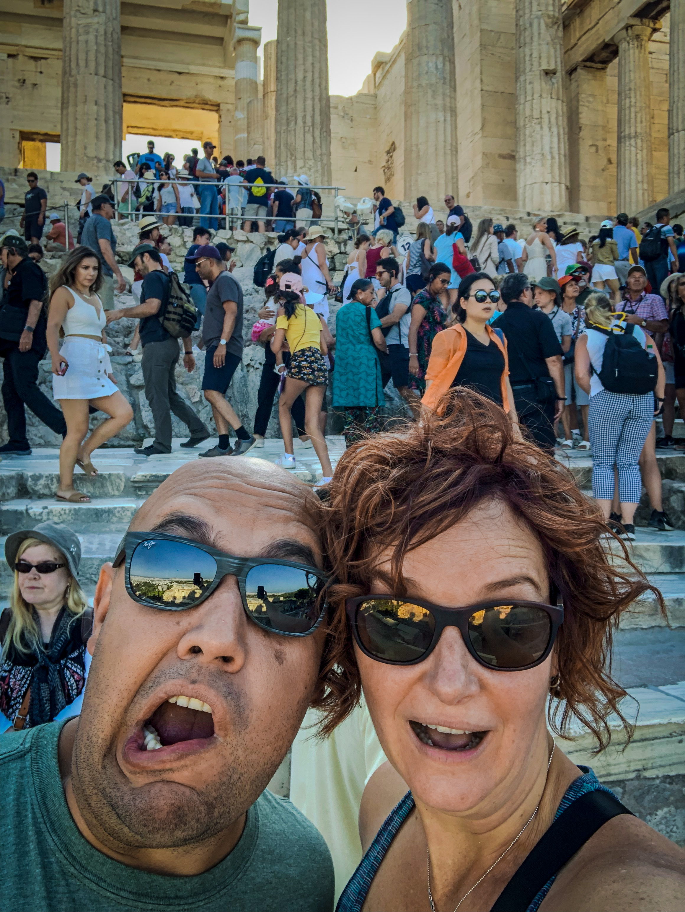 The Parthenon at the Acropolis in Athens, Greece at 9:12am with our shocked faces as the crowd gets even larger behind us.