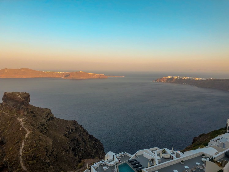 The view from the rooftop patio of Anita’s Villa in Imerovigli, Santorini. The view includes Skaros Rock and the town of Oia in the distance.